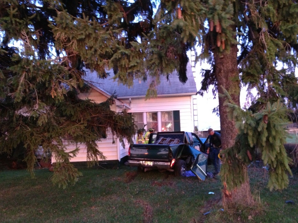 Truck hits house