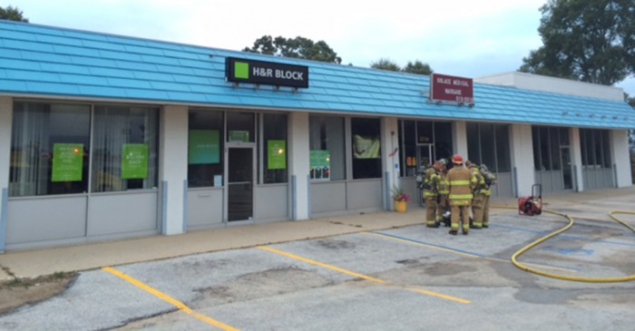 Fire damages massage business; smoke fills plaza.