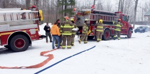 Firefighters stop garage fire from spreading into house.