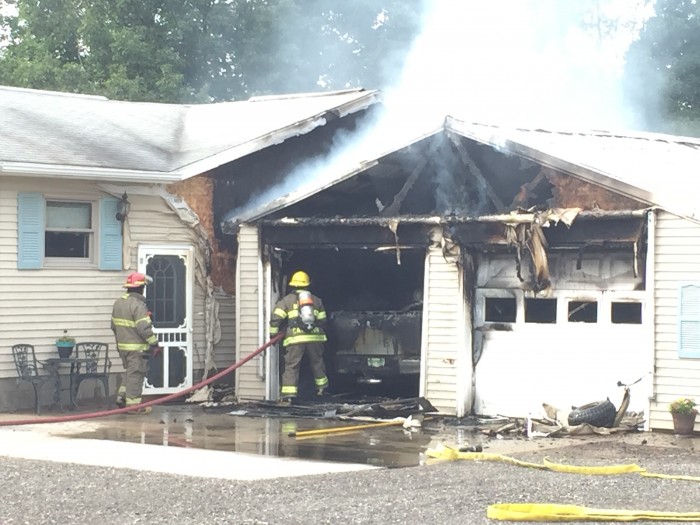 Fire damages vehicles, garage in Riverton.
