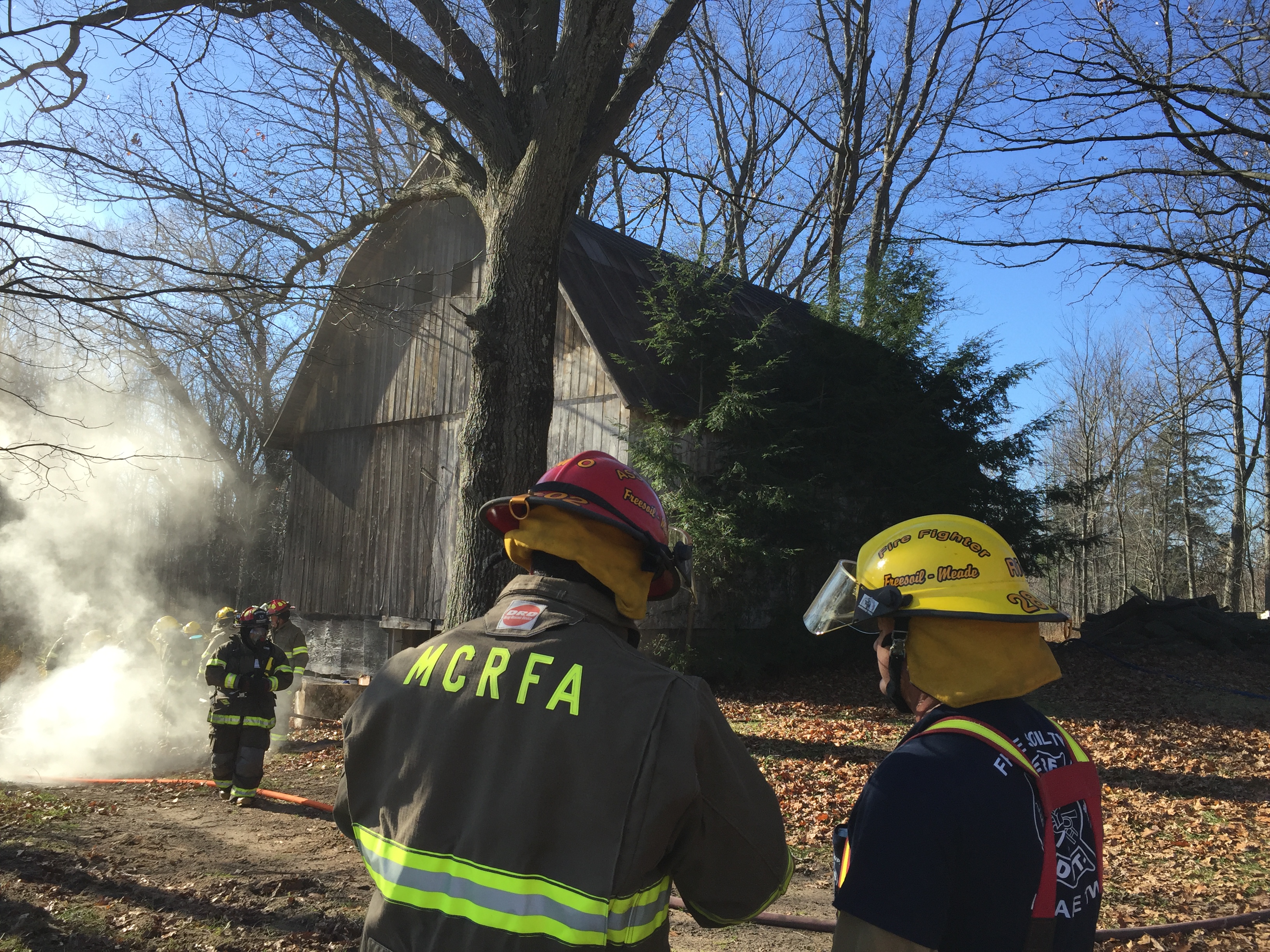 Firefighters extinguish barn fire.