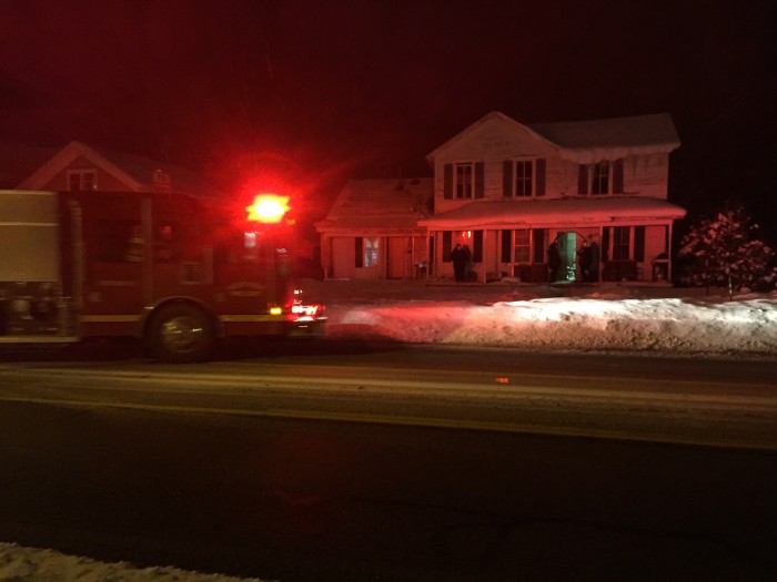 Passing by firefighter extinguishes fire.