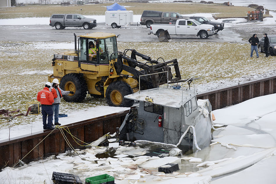 Crews working to lift sunken boat.