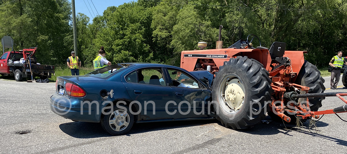 Tractor/car crash results in minor injuries.